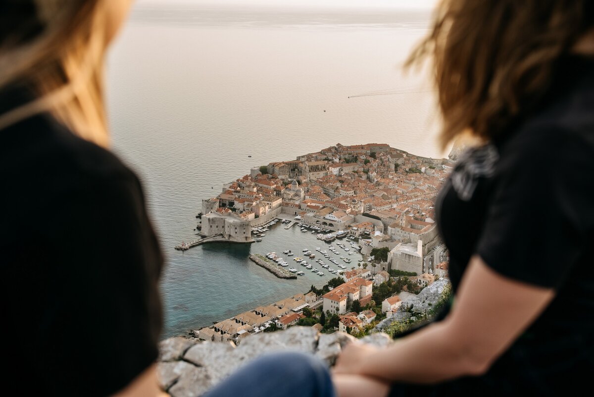 Two girls from the buggy sunset tour watch the unforgettable old town of Dubrovnik from the Srdj mount viewpoint